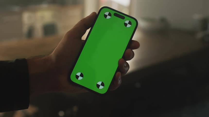 A man holds up his cell phone