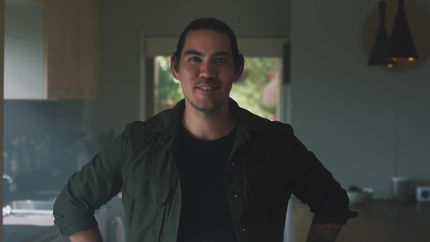 Close up of a young man looking at the camera at home