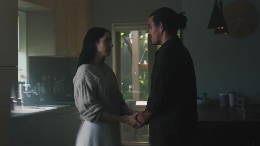 Man and woman are hugging in their kitchen