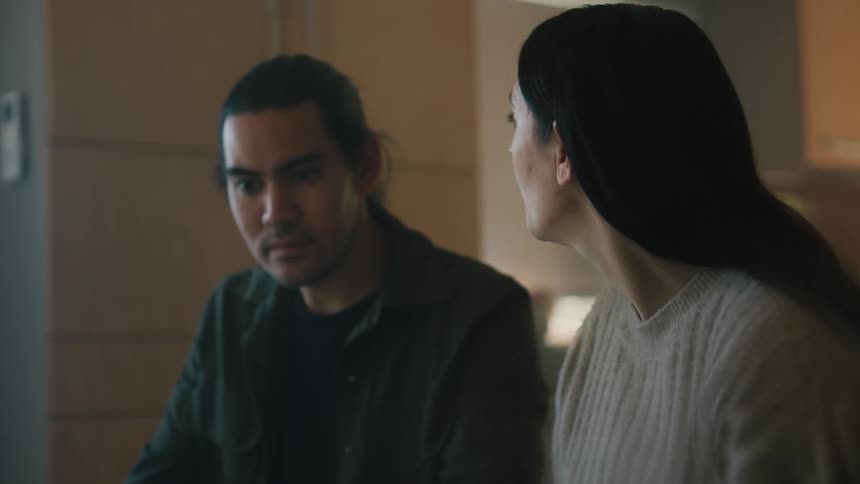 A woman talks with a man