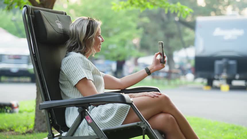 A woman is talking on her phone outside