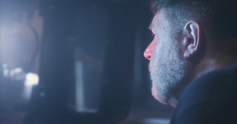 Side portrait of a man in a brightly lit room