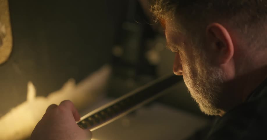 Concentrated man checking a vintage film tape