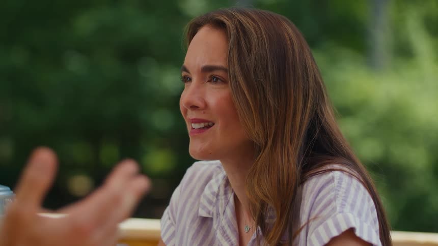A woman is nodding while listening to someone