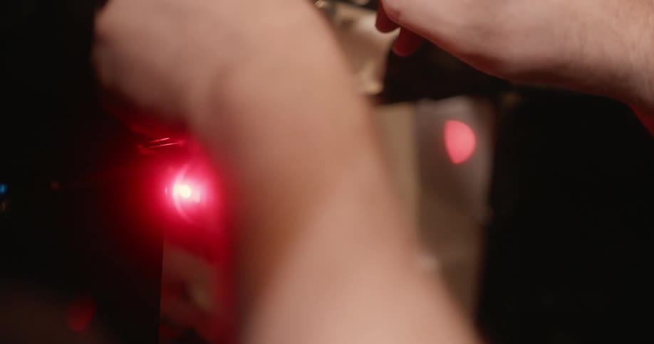 A person is loading film in the projector
