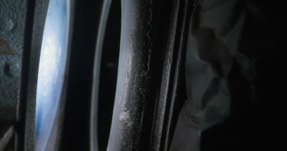 Cross on a metal object that rotates and emits a light