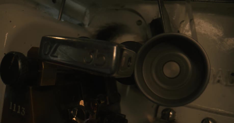 A gear on a motor spins to move an attached belt