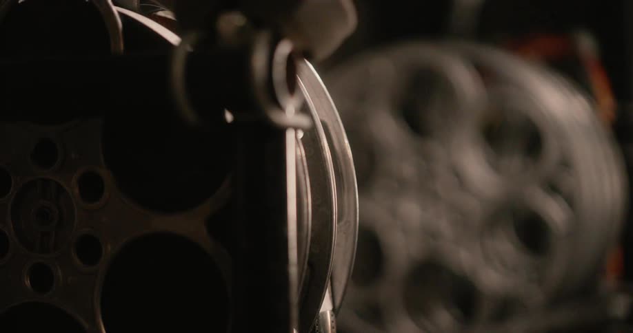 A human hand taking out a roll of film and then putting it back in the same place
