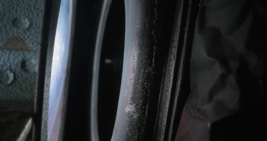 Extreme close up of a vintage metal structure reflecting lights from a film reproduction