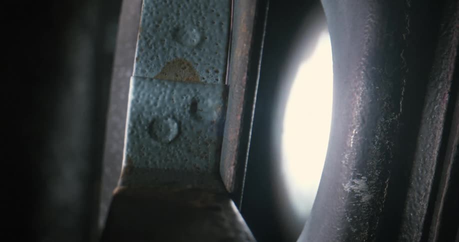 Closeup of a metal structure with lights from a vintage movie player