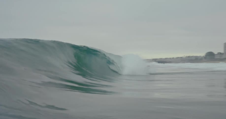 A wave crashes on the beach