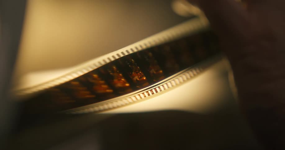 A ribbon of photo frames going to the right and there is a bright light behind it