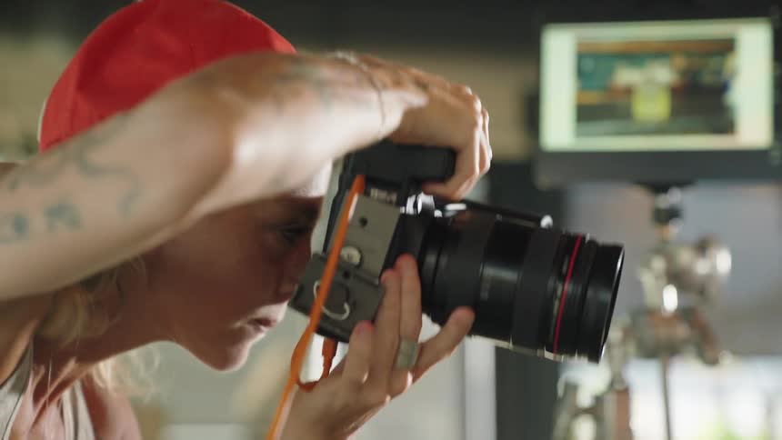 A woman using a professional camera to take a photograph