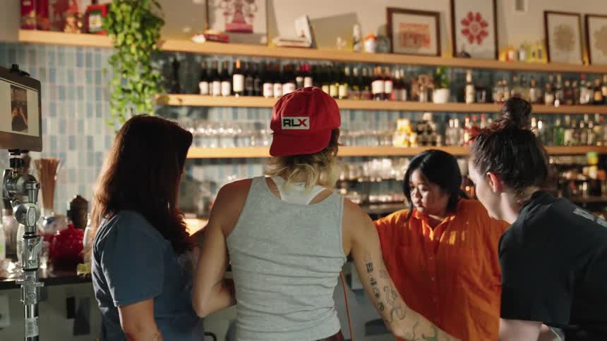 Woman in a bar taking pictures with a professional camera
