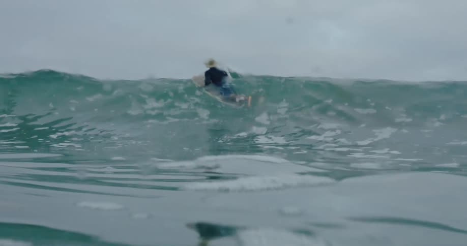 A man is surfing in the rough waters