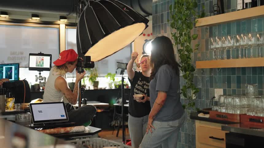 A behindthescenes view of a photo shoot inside a cafe