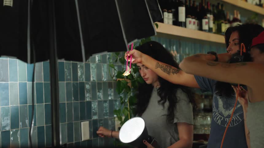 A woman is taking photographs in a restaurant