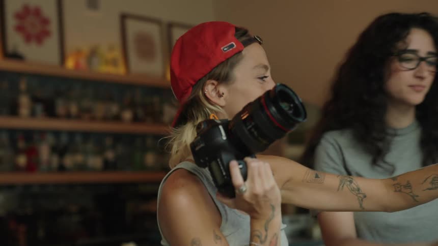 A photographer and her assistant checking photos on a laptop