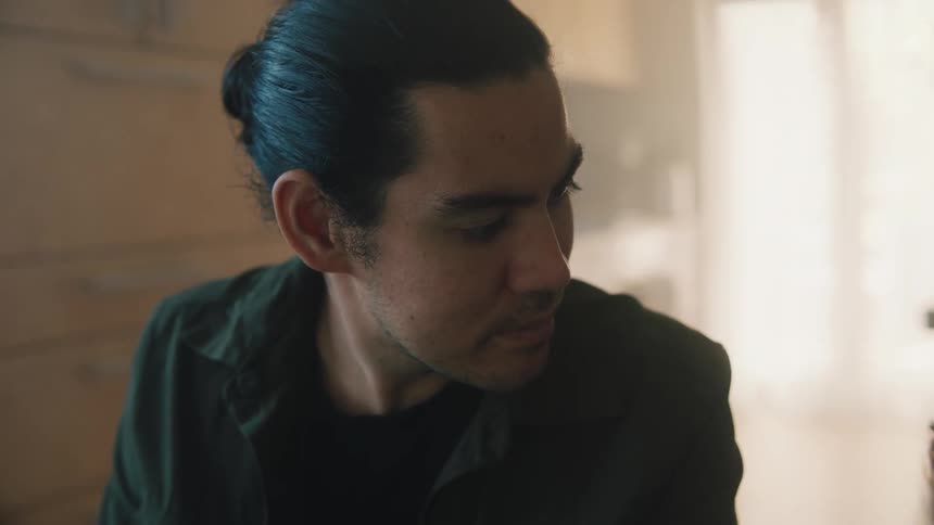 A man is looking over to his side