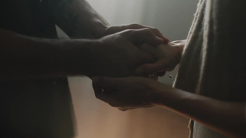 A couple holding and rubbing each others hands