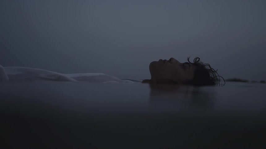 Face of a person floating in the water of a calm sea