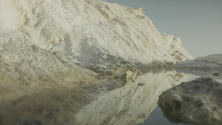 A snowy landscape reflected in still water