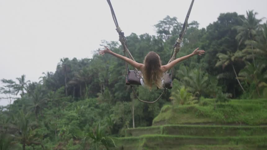 A woman swinging on the swing