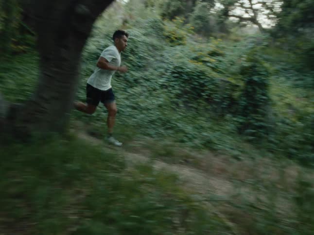 Man running along a forest trail