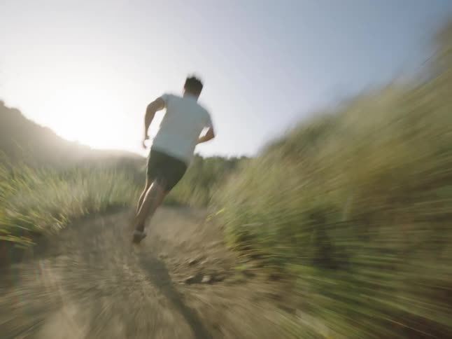 Man running on a mountain trail
