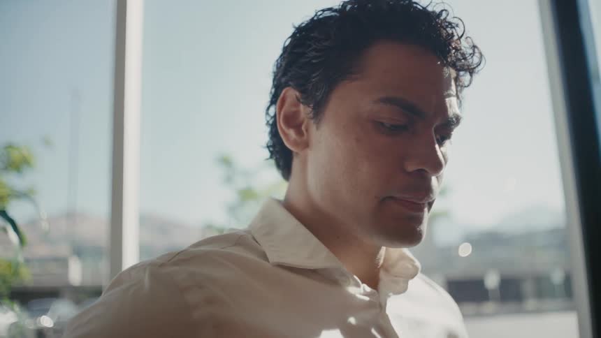 Portrait of a man wearing a white long sleeve shirt in an office environment