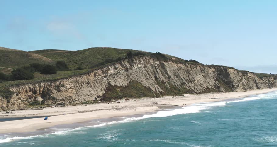 Aerial view of a beach on the edge of a rocky coast