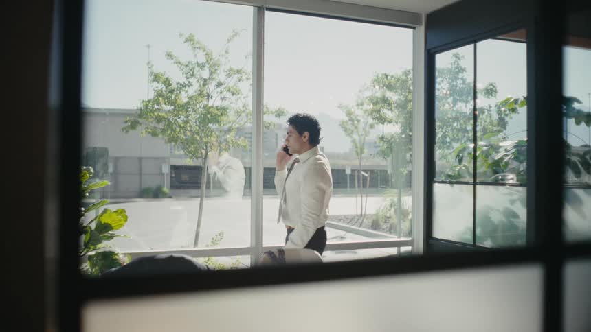A man answers a phone call and celebrates after hanging up