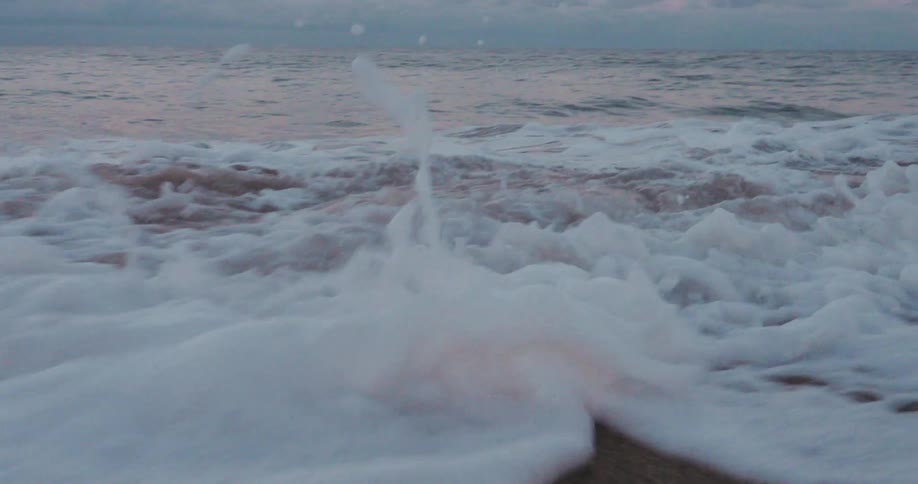 Ocean waves wash over the sandy shore