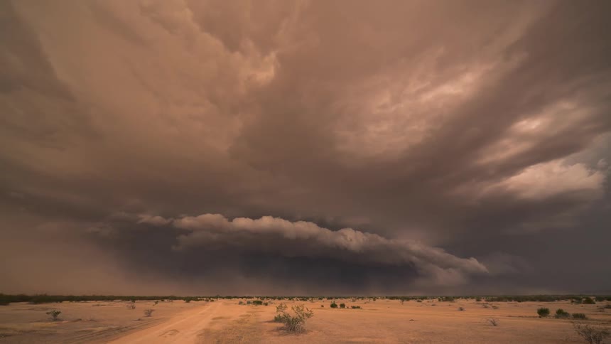 Scene with a high speed foggy tornado with thunder above a desert area