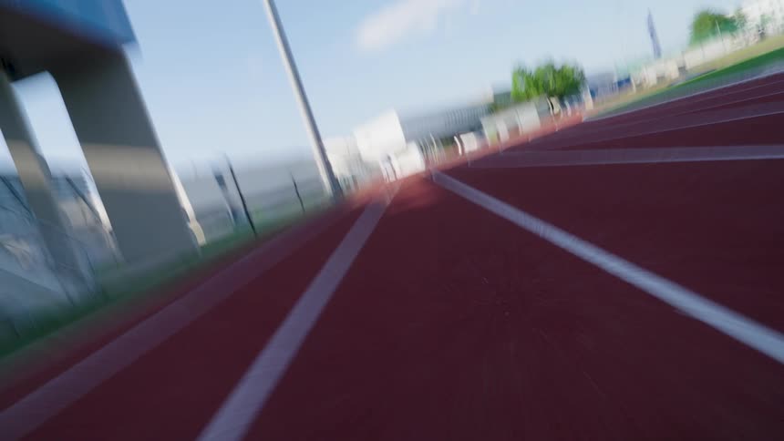 Point of view of a person running on an athletics track