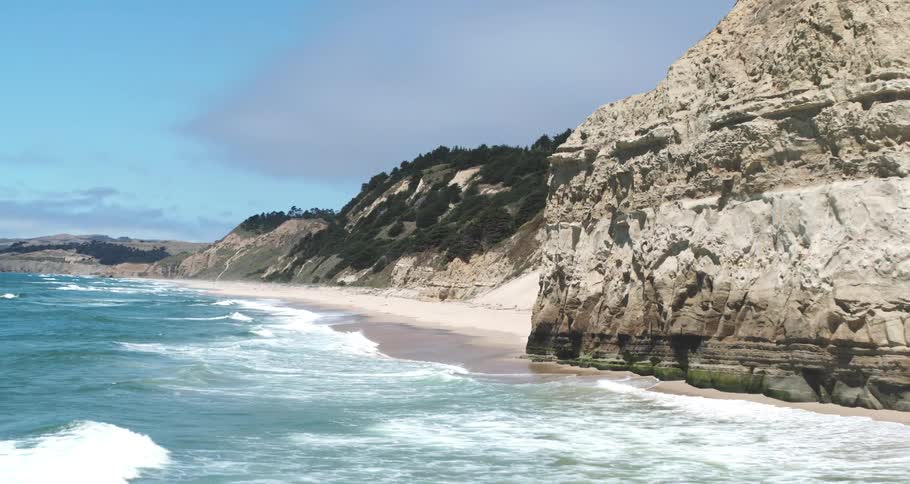 Aerial view of a beach on the edge of a rocky coast