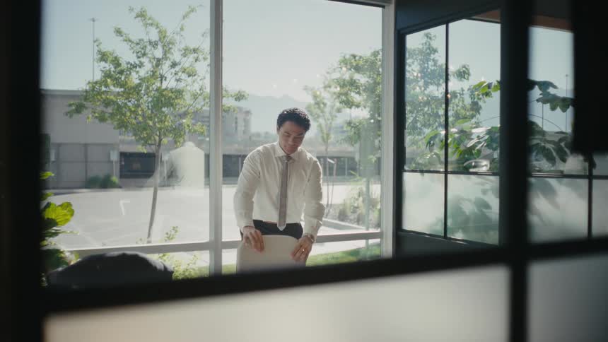 Man arranging a chair in an office room