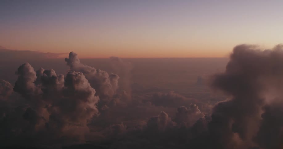 Landscape of a sea of clouds against a sky in shades of purple and orange