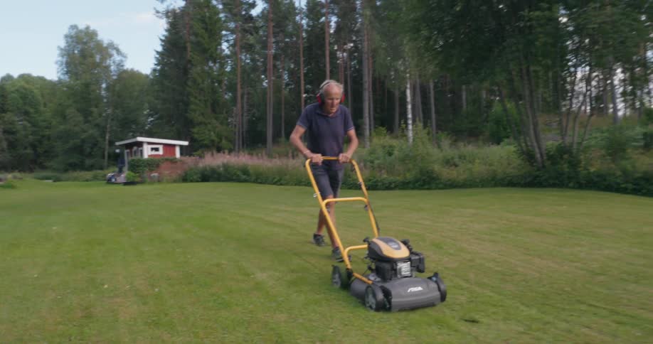 A man is mowing his lawn