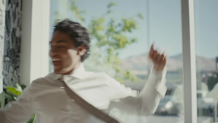 Man inside an office room dancing happily