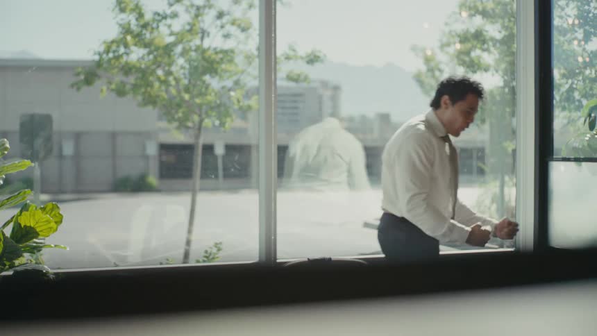 Man inside an office room jumping and vibrating with joy