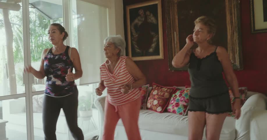 Three women in a room dancing