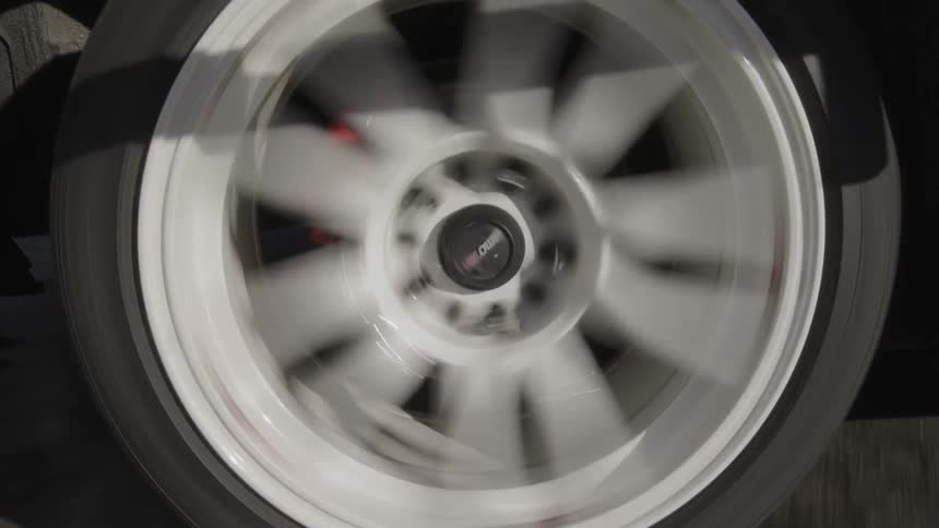 Closeup of vehicle tire moving across the road