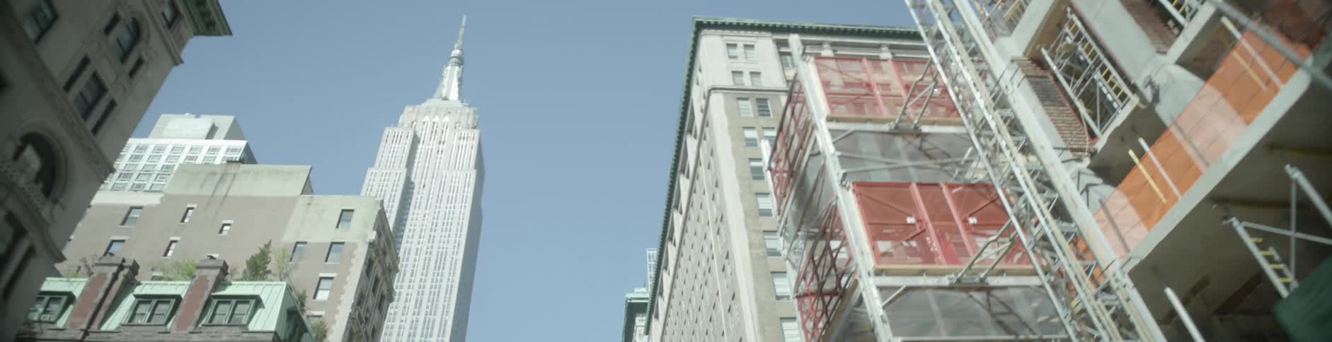 Tall buildings line the clear sky