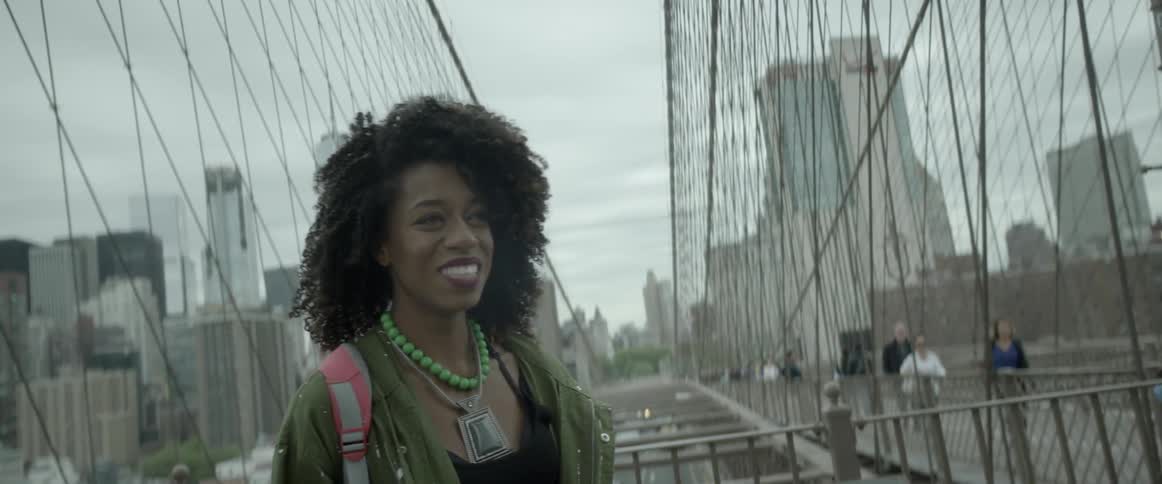 A woman smiles as her hair blows in the breeze