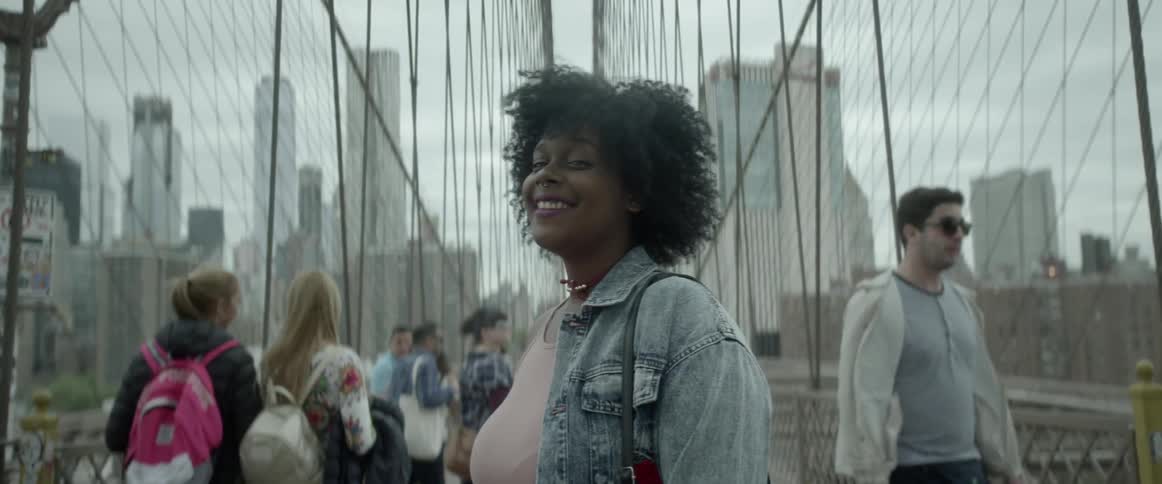 A woman smiles as her hair blows in the breeze