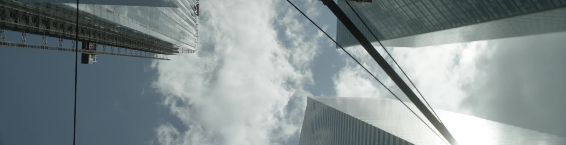 Tops of skyscrapers are visible on a cloudy day