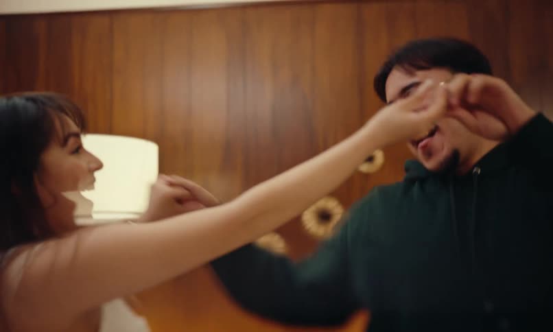 Two friends dancing and another woman sitting next to them