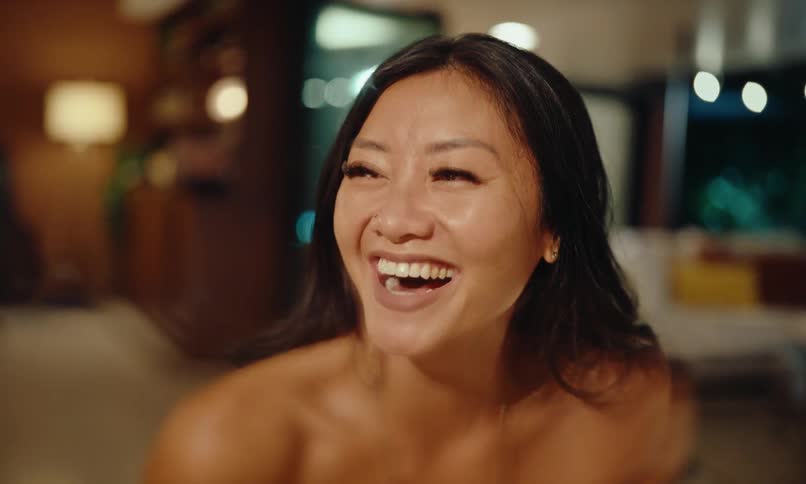 A woman dining on a fancy restaurant smiling and laughing