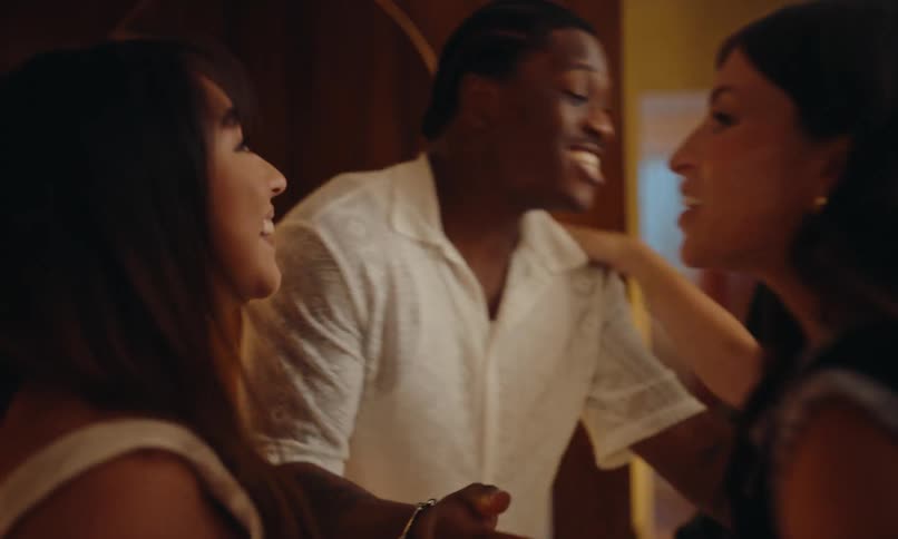Couple of friends greeting each other happily inside the house
